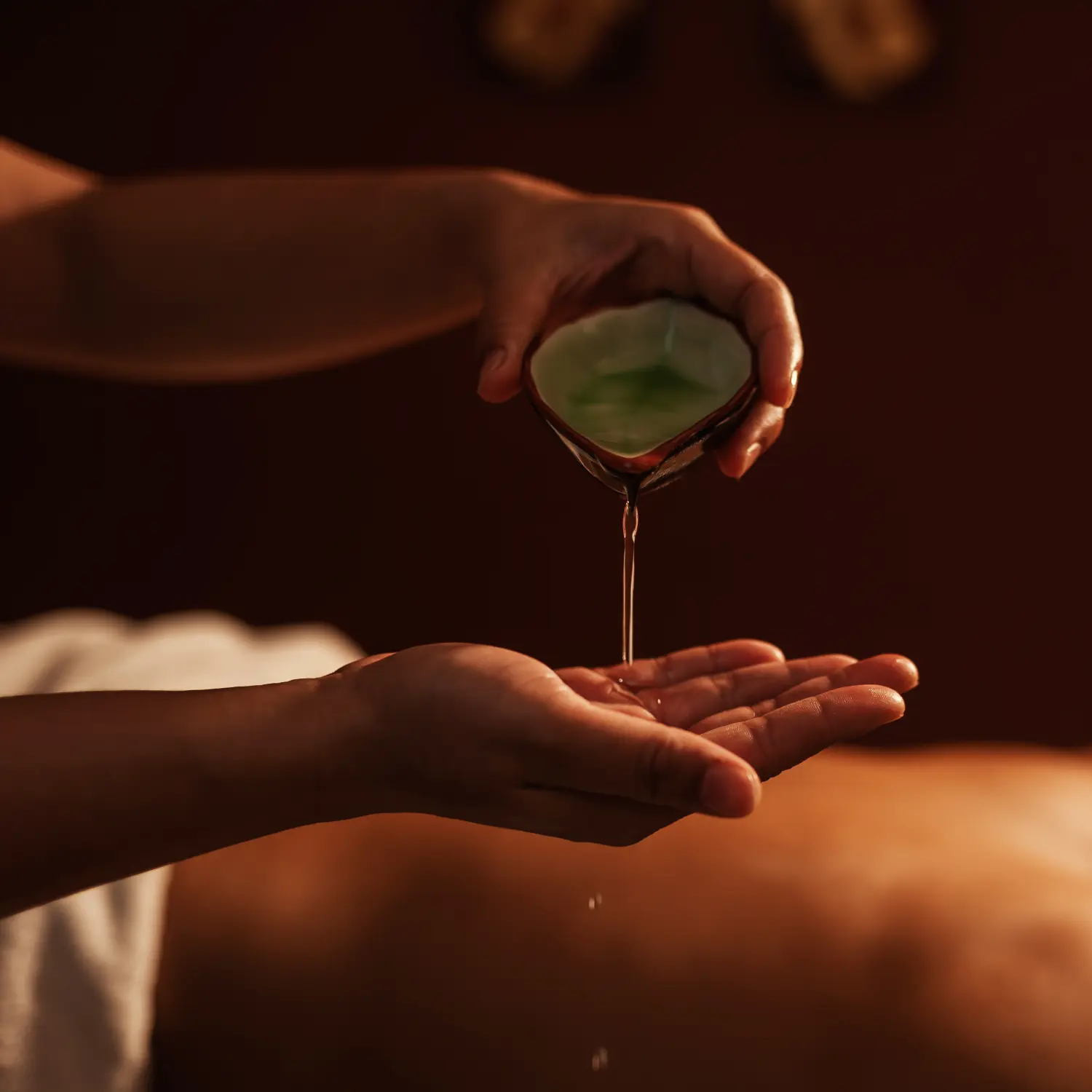 Hand pouring massage oil